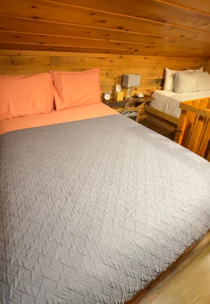 The loft contains a queen bed and a full bed at the View Treehouse
